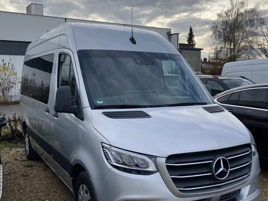 9-seater Sprinter side angle showing high roof and long body