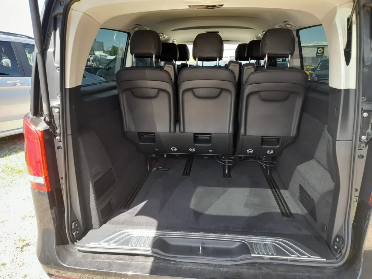 Open rear trunk of a Mercedes 8-seater V-Class van in Germany showing the carpeted luggage space behind the back row of seats