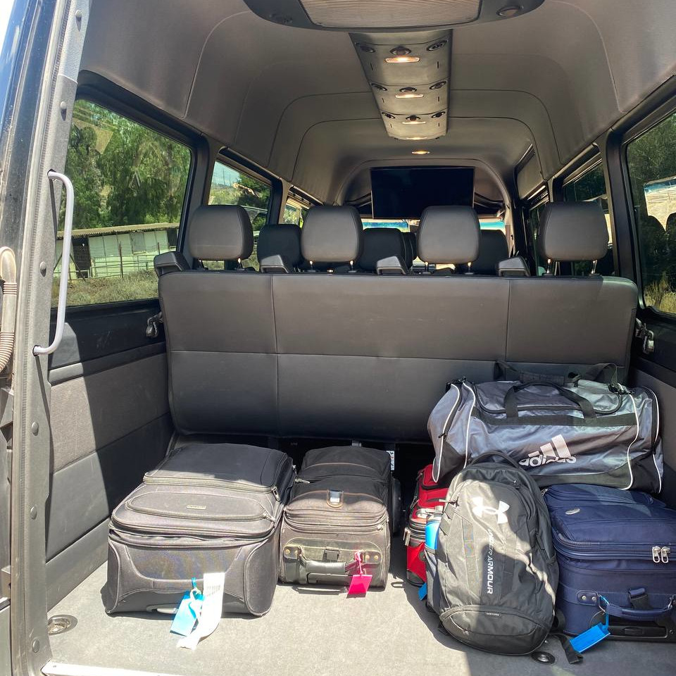Mercedes-Benz Sprinter 15-passenger van with rear cargo space open showing luggage capacity for corporate group transportation