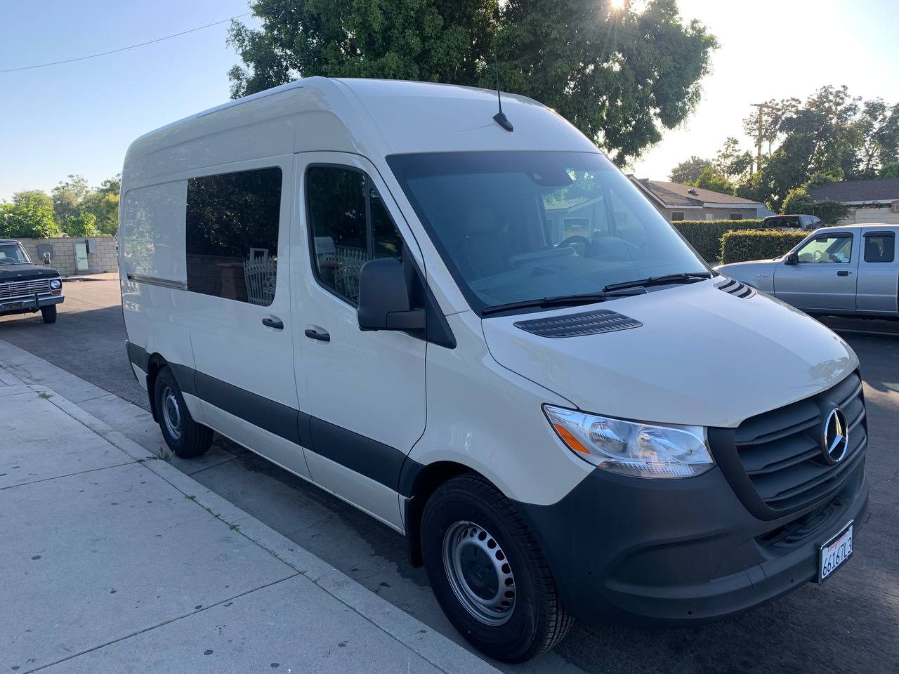 Front view of the short 144 WB Mercedes-Benz Sprinter crew cargo van with tinted windows by the rear seats