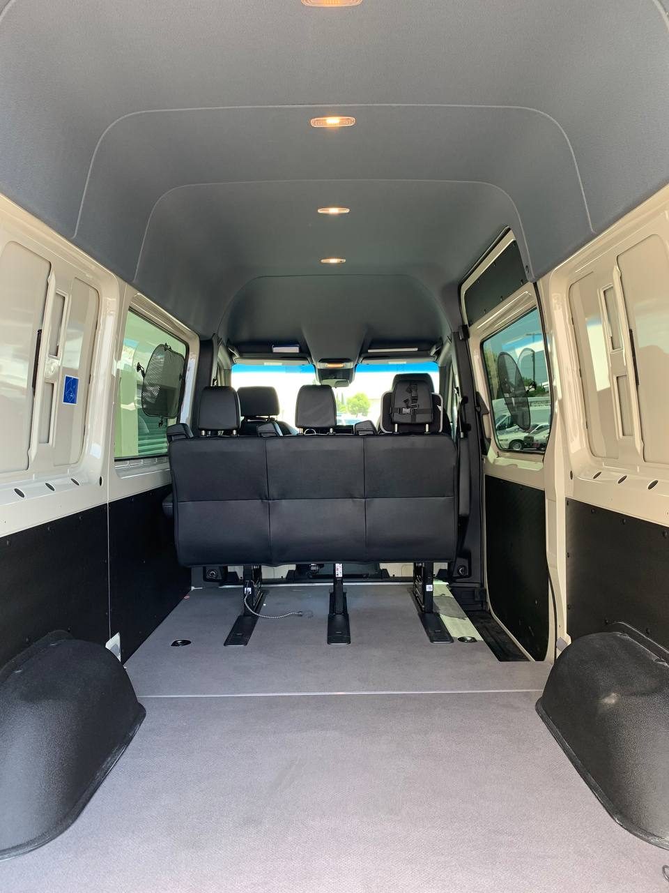 8.5 ft cargo space with wheel wells behind the rear bench of the 5 seater crew cargo Sprinter