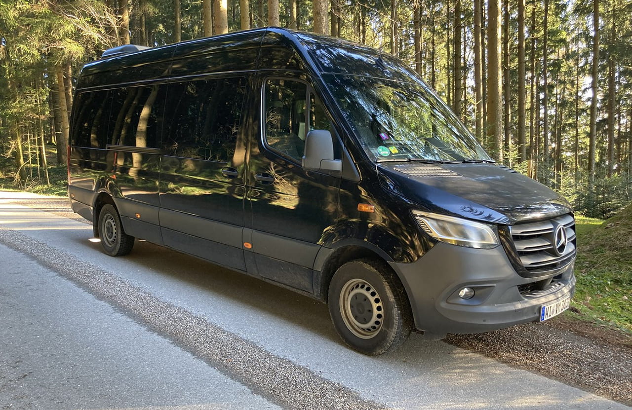 Mercedes-Benz Sprinter 9 passenger van on a forest road in southern Germany