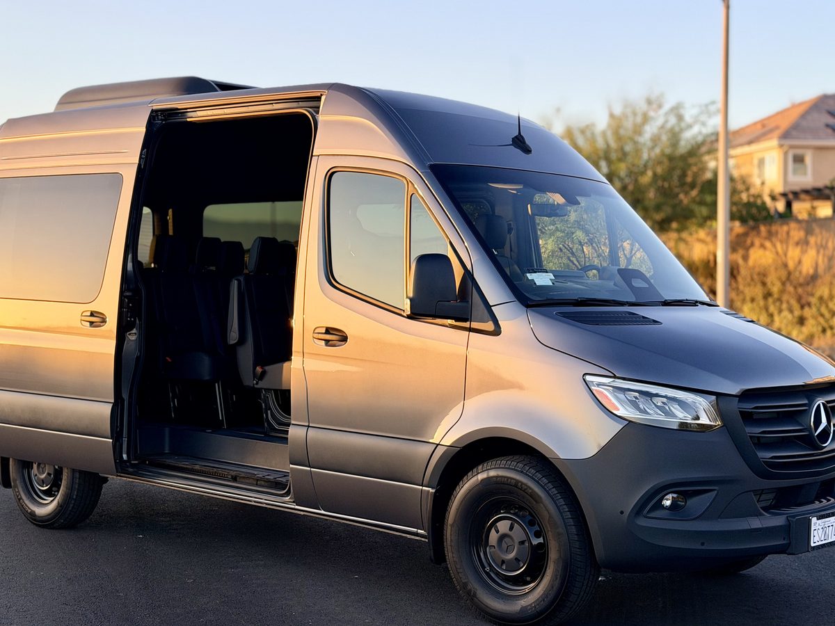 Mercedes-Benz Sprinter 12-passenger van with the sliding side door open, available to rent in Anaheim, California