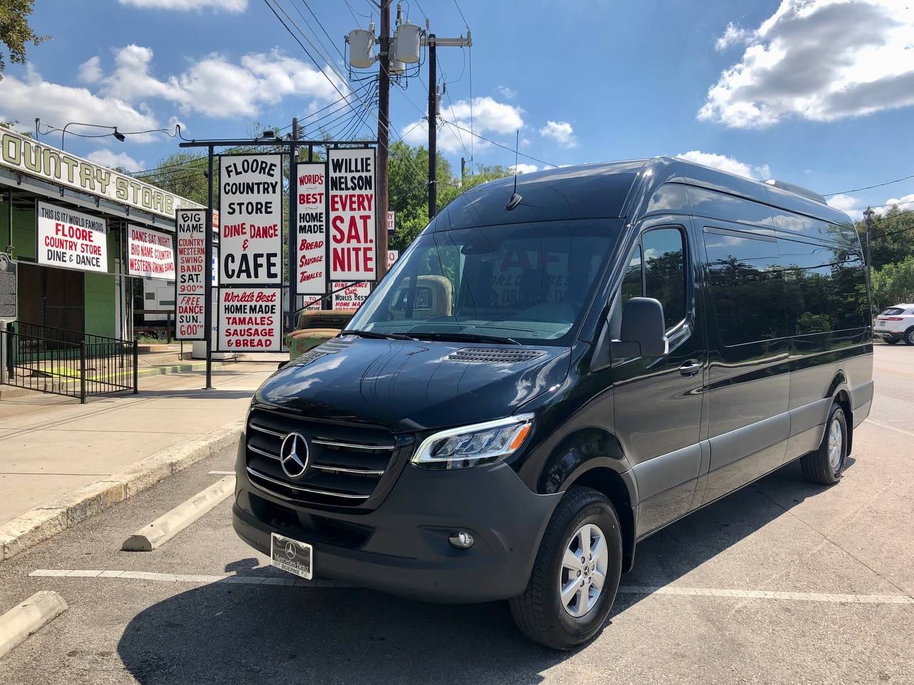 Black Sprinter passenger van outside Floore Country Store in the Texas Hill Country — Austin rental for group road trips