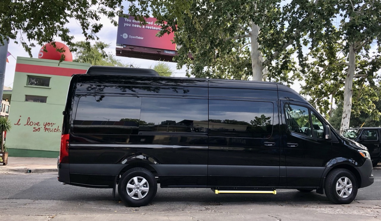 Black Sprinter passenger van side profile parked near the I Love You So Much mural in South Congress Austin