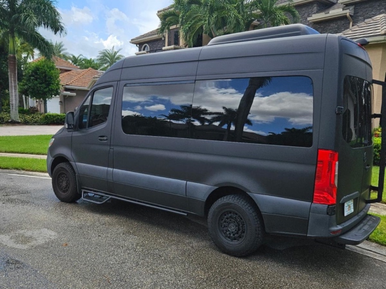 Matte grey Sprinter passenger van with roof ladder available for Austin van rentals and Hill Country adventures