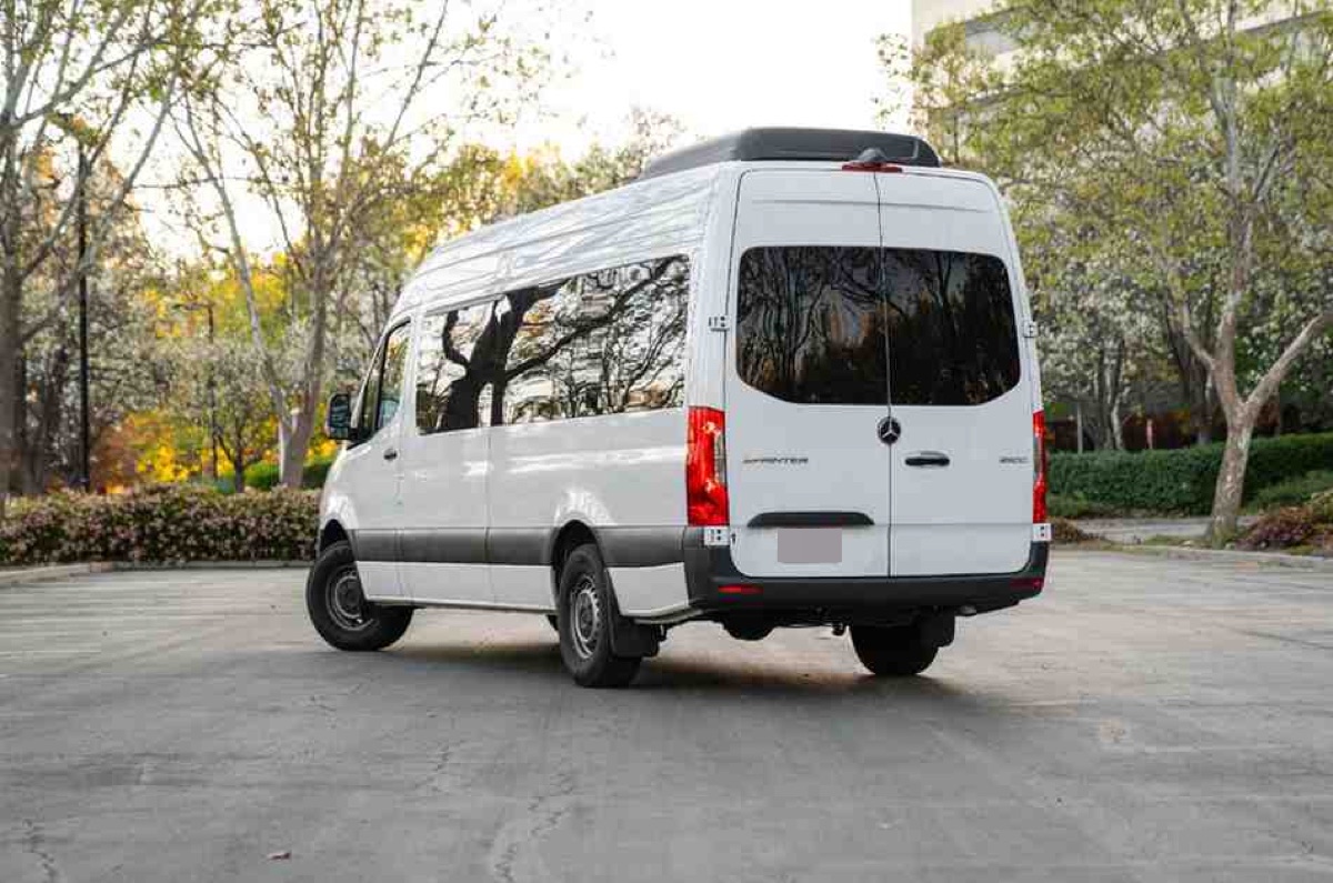 Rear view of a white high roof Mercedes-Benz Sprinter passenger van available to rent on the Big Island of Hawaii