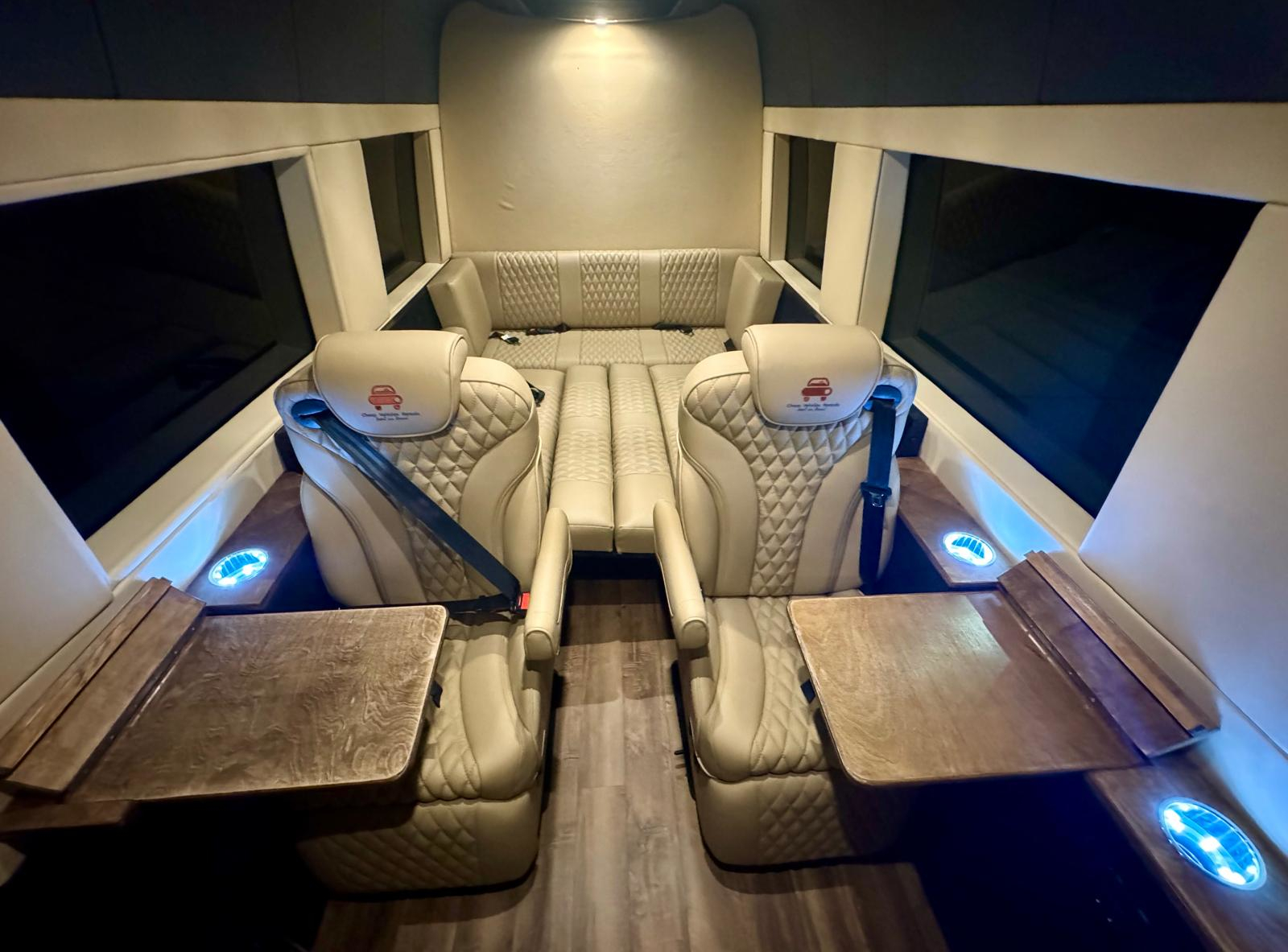 VIP luxury Sprinter van cabin with cream leather first-class seats and fold-out tables in Dallas, Fort Worth