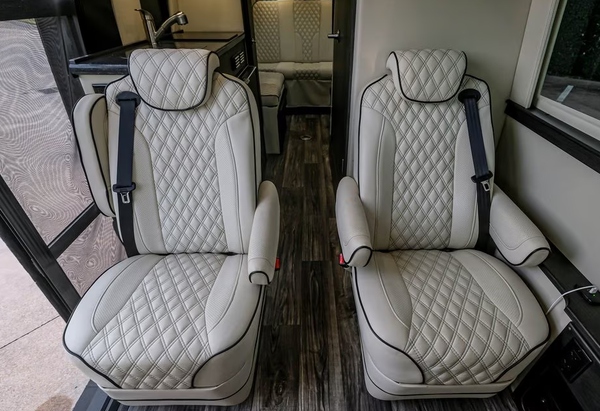 VIP cream leather captain chairs inside Sprinter van rental in Dallas / Fort Worth, Texas