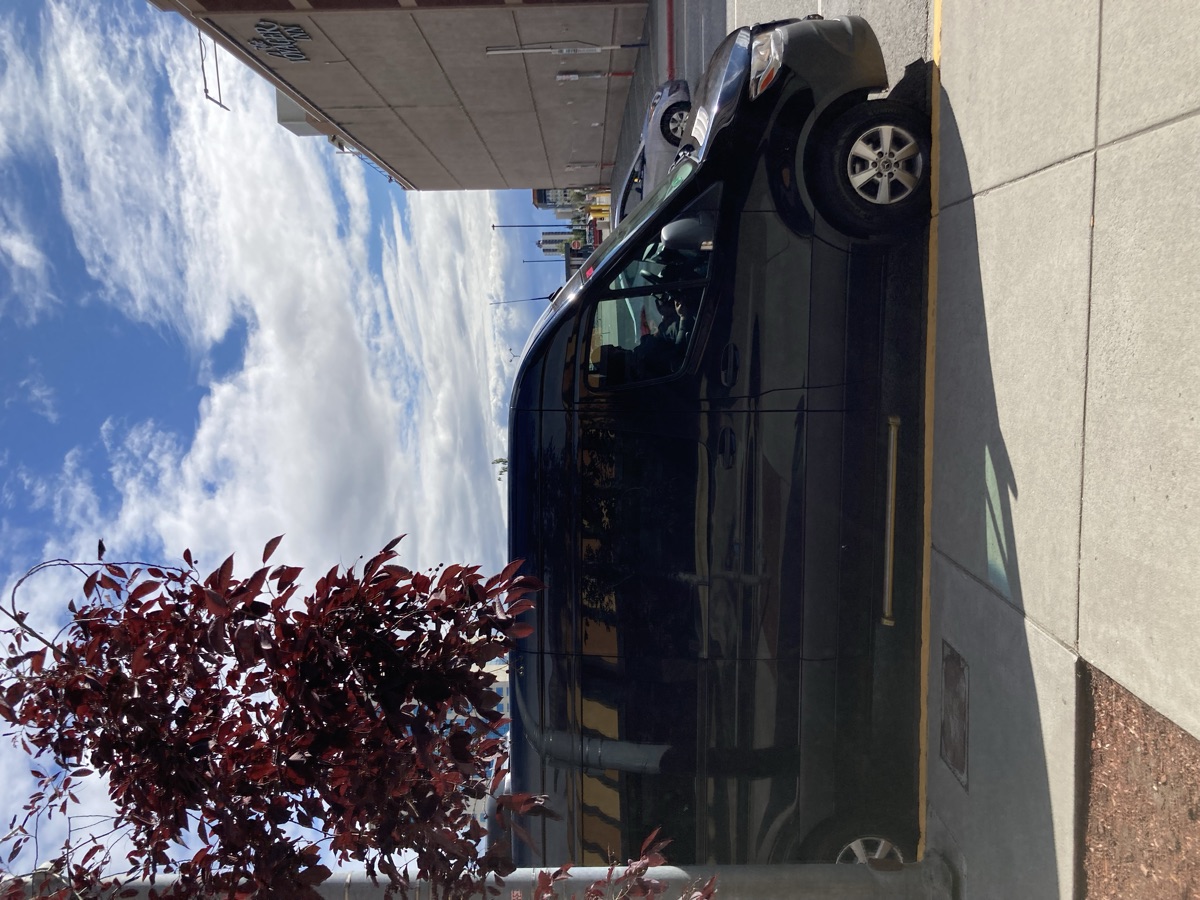 Sprinter van for rent in Denver with mountain backdrop