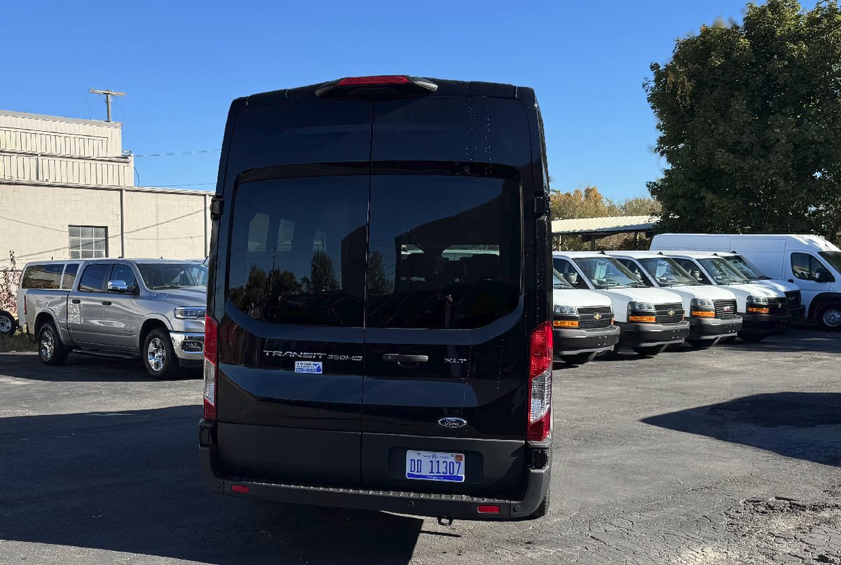 Rear view of a black Ford Transit 350 HD XLT high roof passenger van — Detroit van rental pickup near DTW