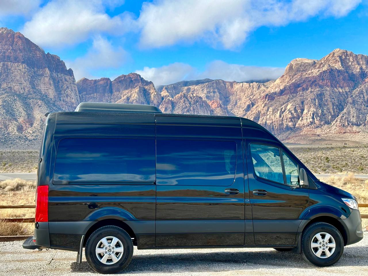 Black Mercedes-Benz Sprinter high-roof van rental at Red Rock Canyon near Las Vegas