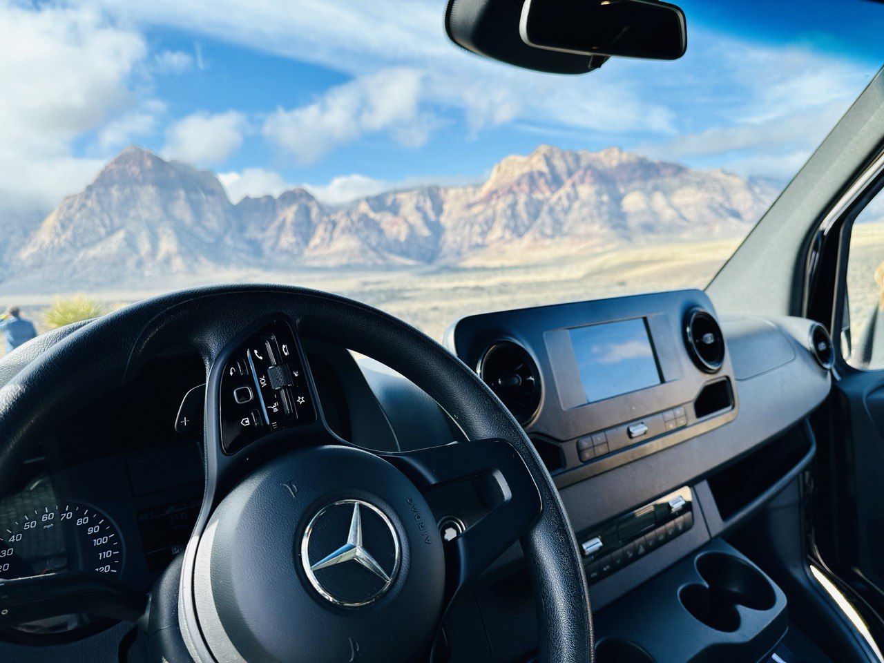 Mercedes-Benz Sprinter van interior and dashboard with Red Rock Canyon view near Las Vegas