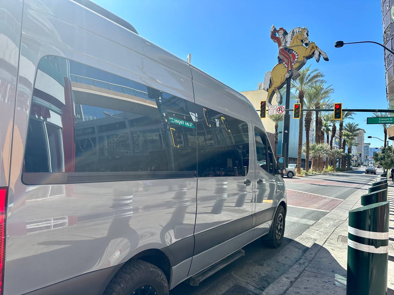 Silver Mercedes-Benz Sprinter van rental on Fremont Street near Vegas Vic, downtown Las Vegas