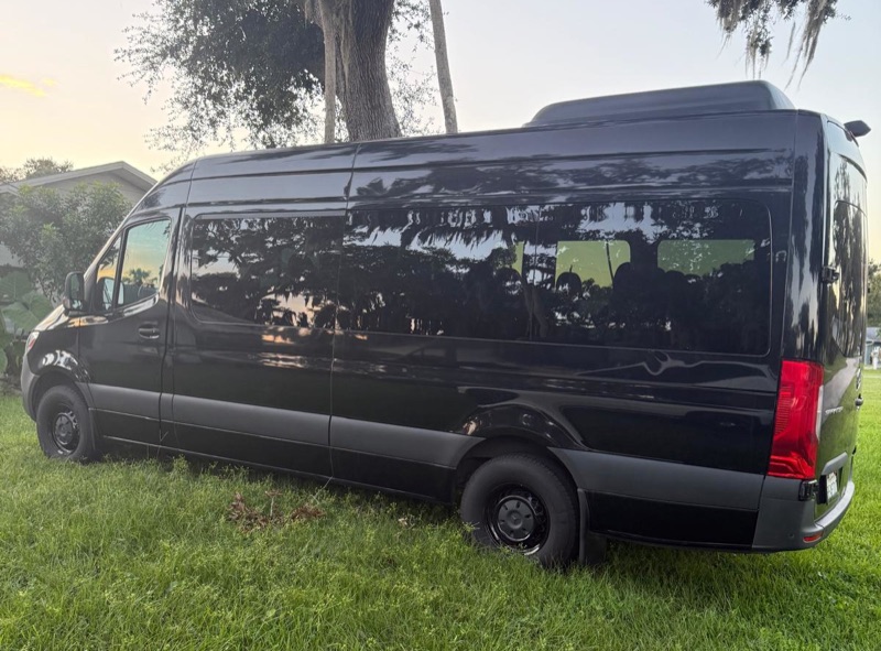 Black 15-seater Sprinter trunk and left side in Miami
