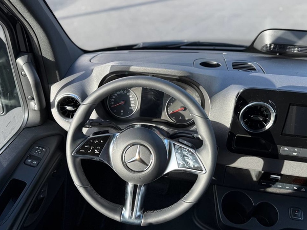 Black 2025 Sprinter 15-seater passenger van side view for San Antonio group travel rentals