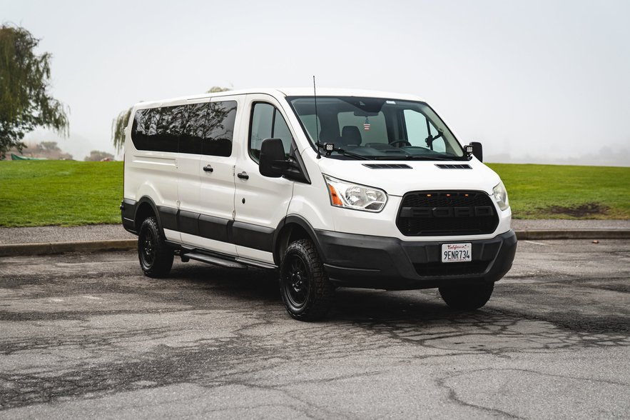 Ford Transit low-roof 13-15 seater white van rental in San Jose
