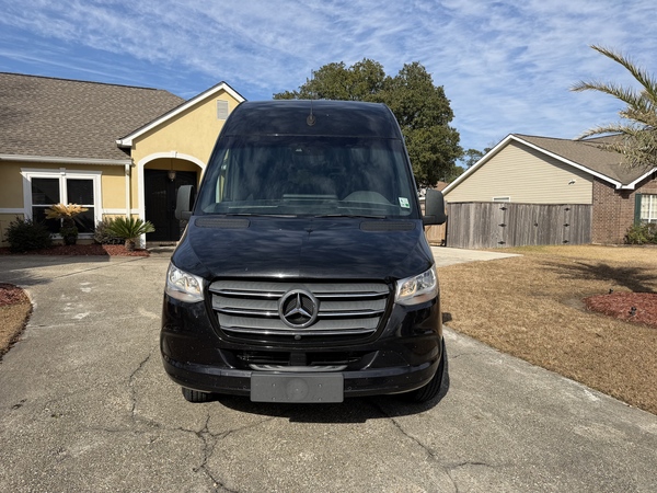 Black Mercedes-Benz Sprinter passenger van front view available for rent in St. Louis, MO