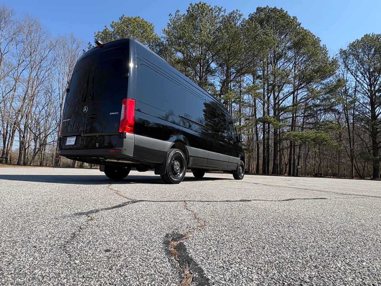 Black Mercedes-Benz Sprinter 2500 passenger van rear view for St. Louis group travel and STL airport pickups