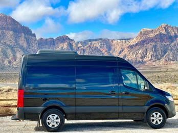 Sprinter van side profile parked with a clean background