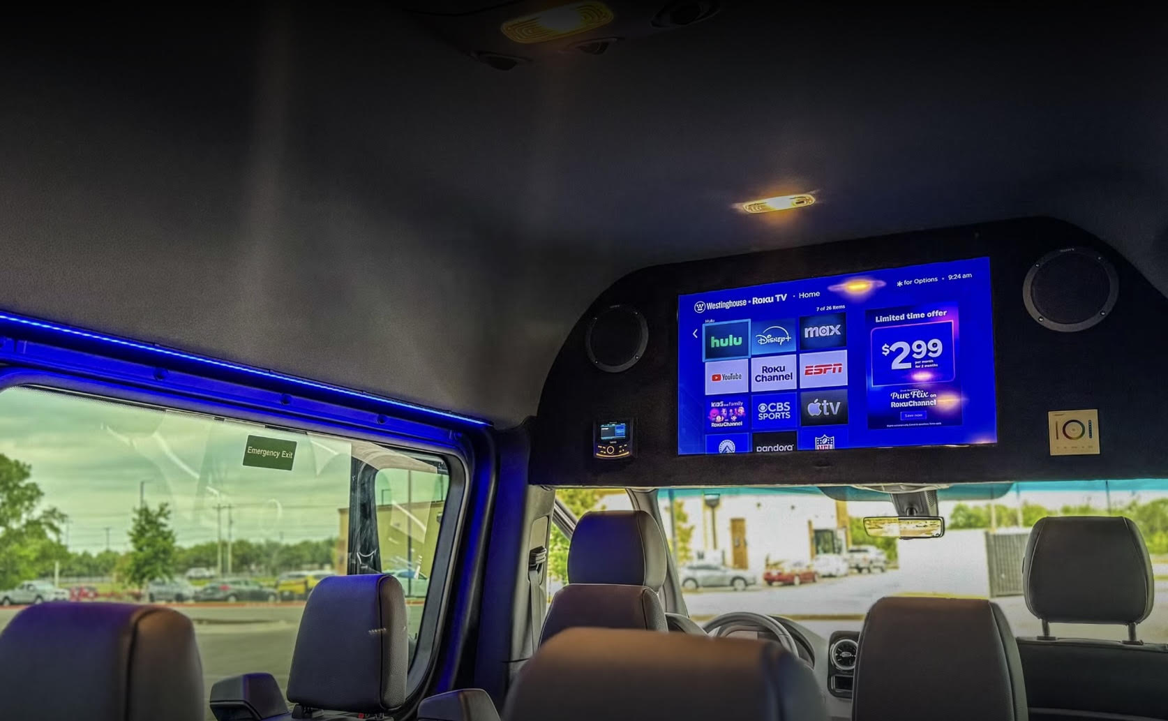 Overhead TV mounted on the front ceiling inside the van