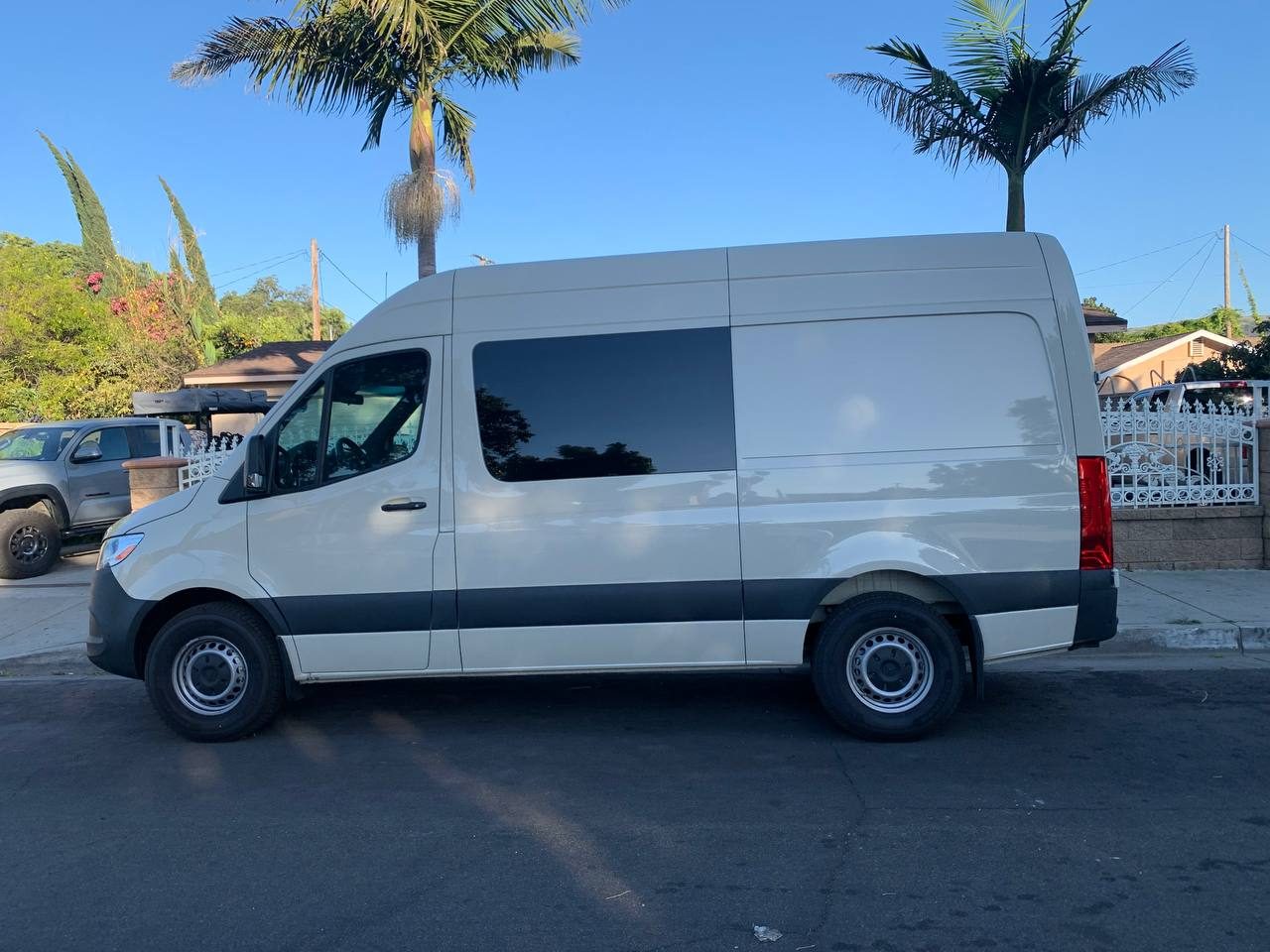 Side view of the short 144 inch wheelbase Mercedes-Benz Sprinter 5 seater crew cargo van in sand gray
