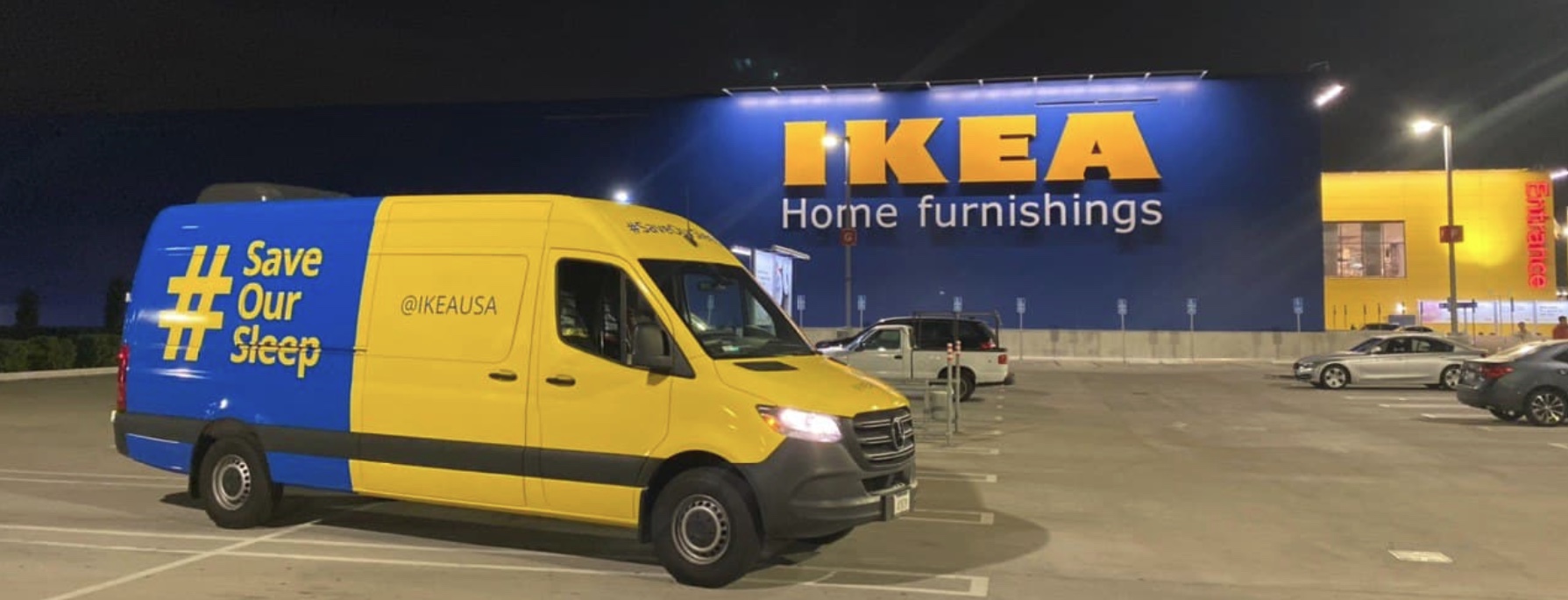 Blue and yellow full wrap on a sprinter van parked outside an IKEA store at night