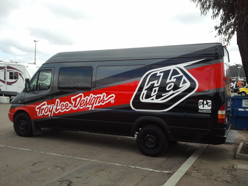 Black and red Troy Lee Designs full wrap on a high roof sprinter van